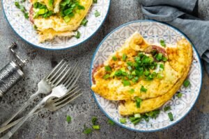 Omelet or omelette with fresh green onion, scrambled eggs